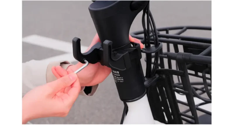 電動子供乗せ自転車に荷物フックを取り付ける様子のクローズアップ写真
