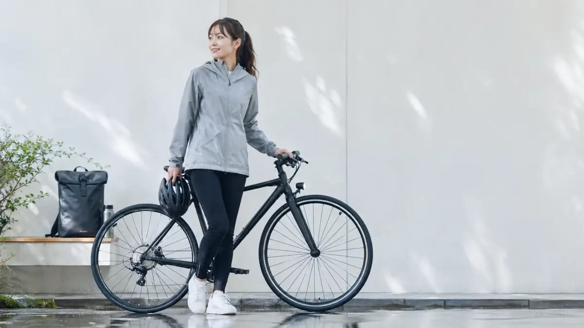 2ミリの 雨自転車で必要な服装と装備を準備する日本人女性